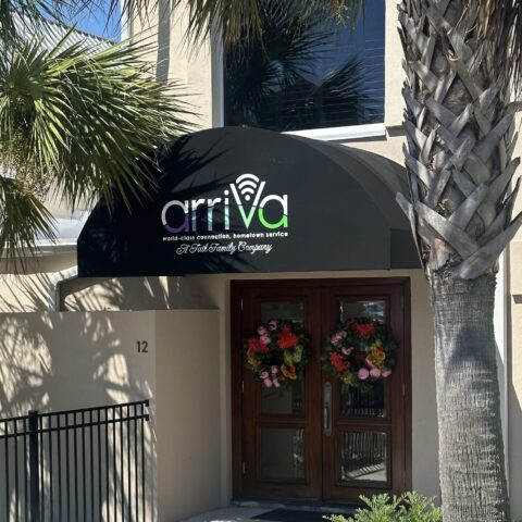 Half-round traditional awning with fabric cover and custom applied vinyl graphics.1