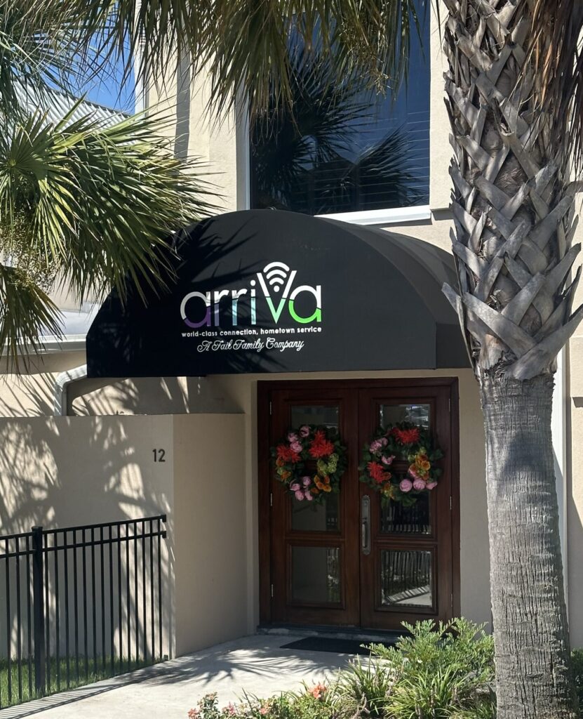 Half-round traditional awning with fabric cover and custom applied vinyl graphics.1